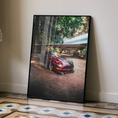Ford Mustang S550 poster with red car under trees, sleek automotive wall art in black frame.