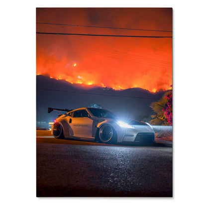 Nissan 370z sports car with wide body kit and glowing headlights against fiery orange sky poster wall art.