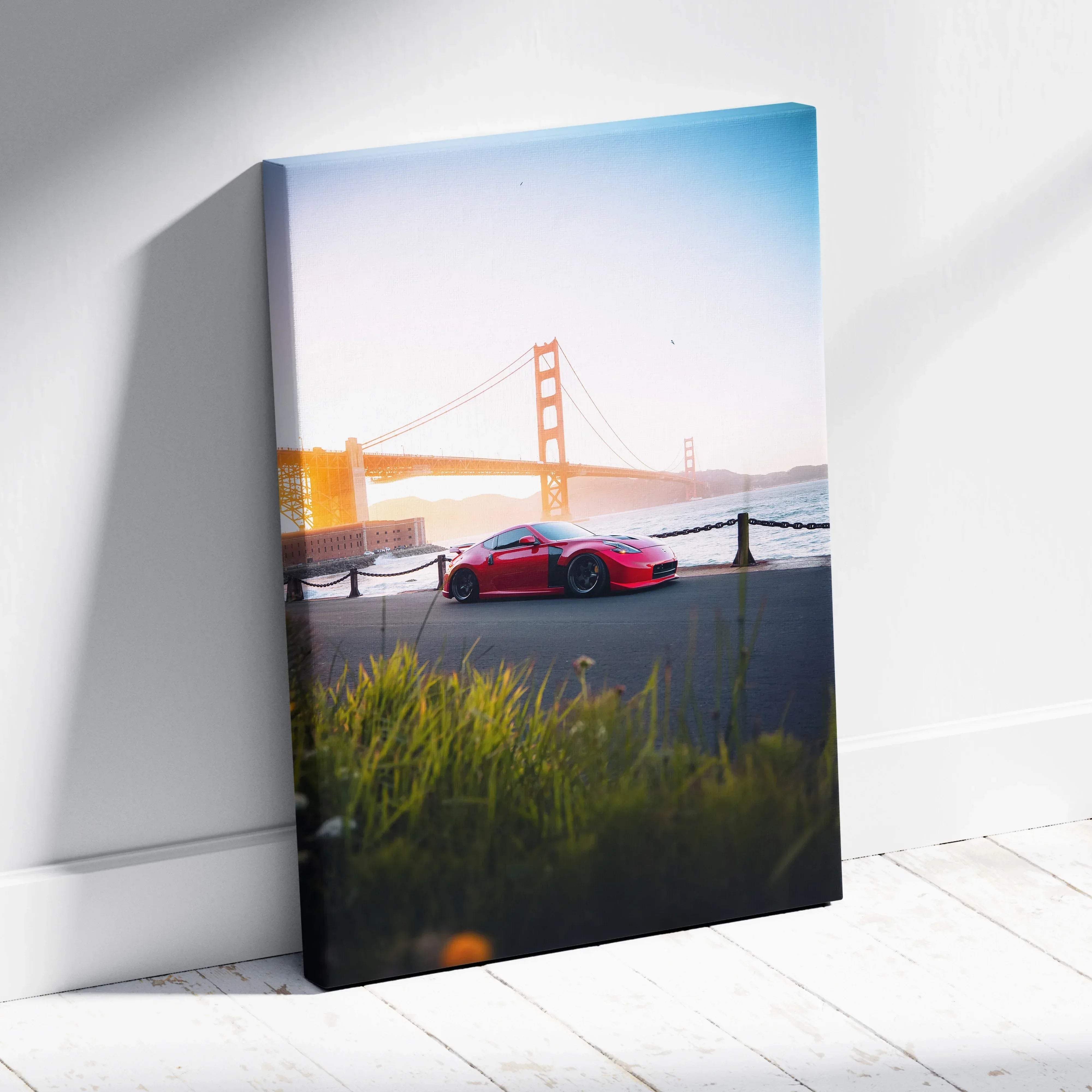 Canvas wall art featuring a red nissan 370z sports car parked near golden gate bridge at sunset vertical print