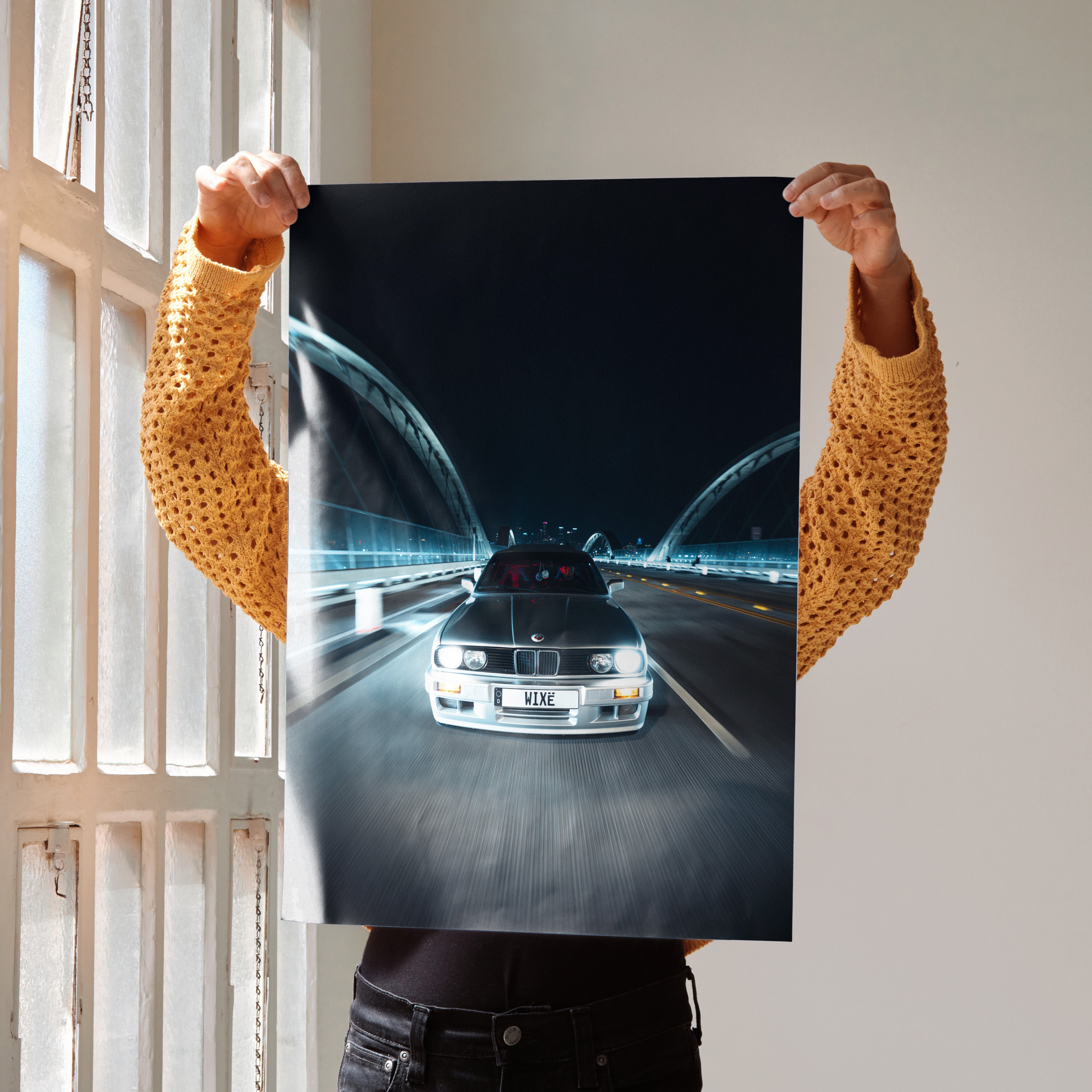 BMW E30 car driving at night on bridge poster wall art with sleek, modern design.