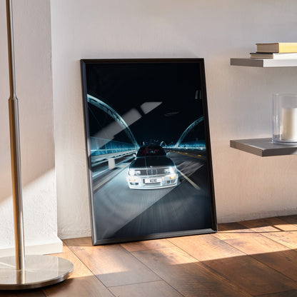 BMW E30 Euro car driving at night wall art poster with city lights and reflections in a black frame.