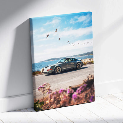 Porsche 911 parked by the sea with blue sky and birds, vertical canvas wall art.