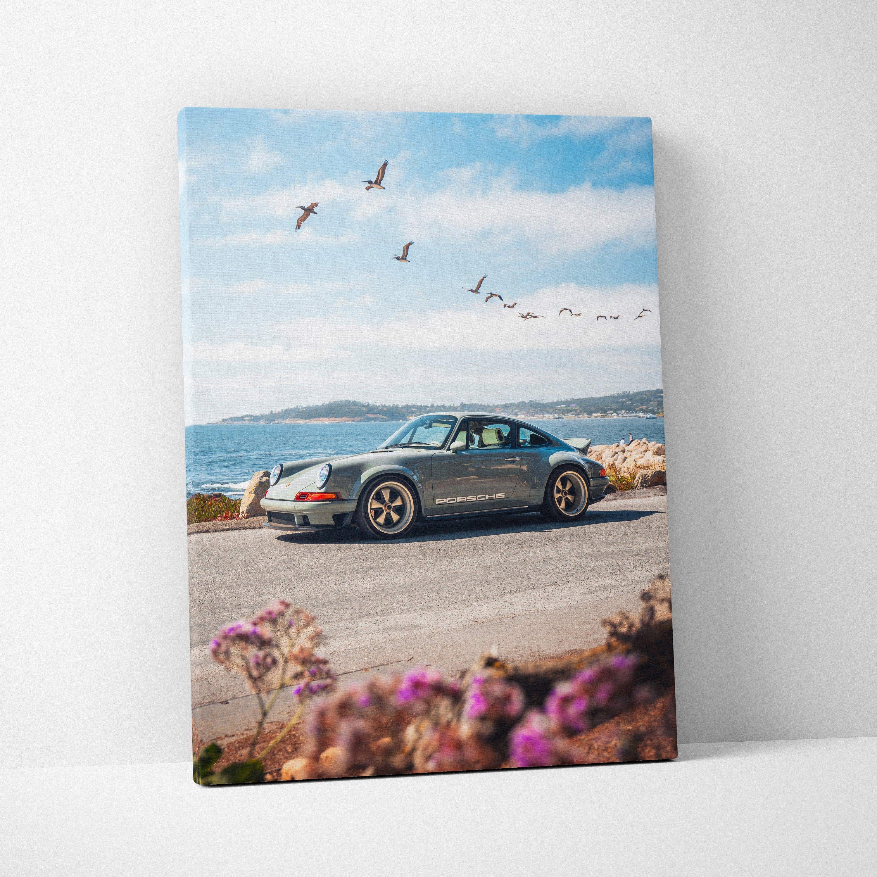 Vertical Porsche 911 classic car canvas wall art with coastal landscape and flying birds.