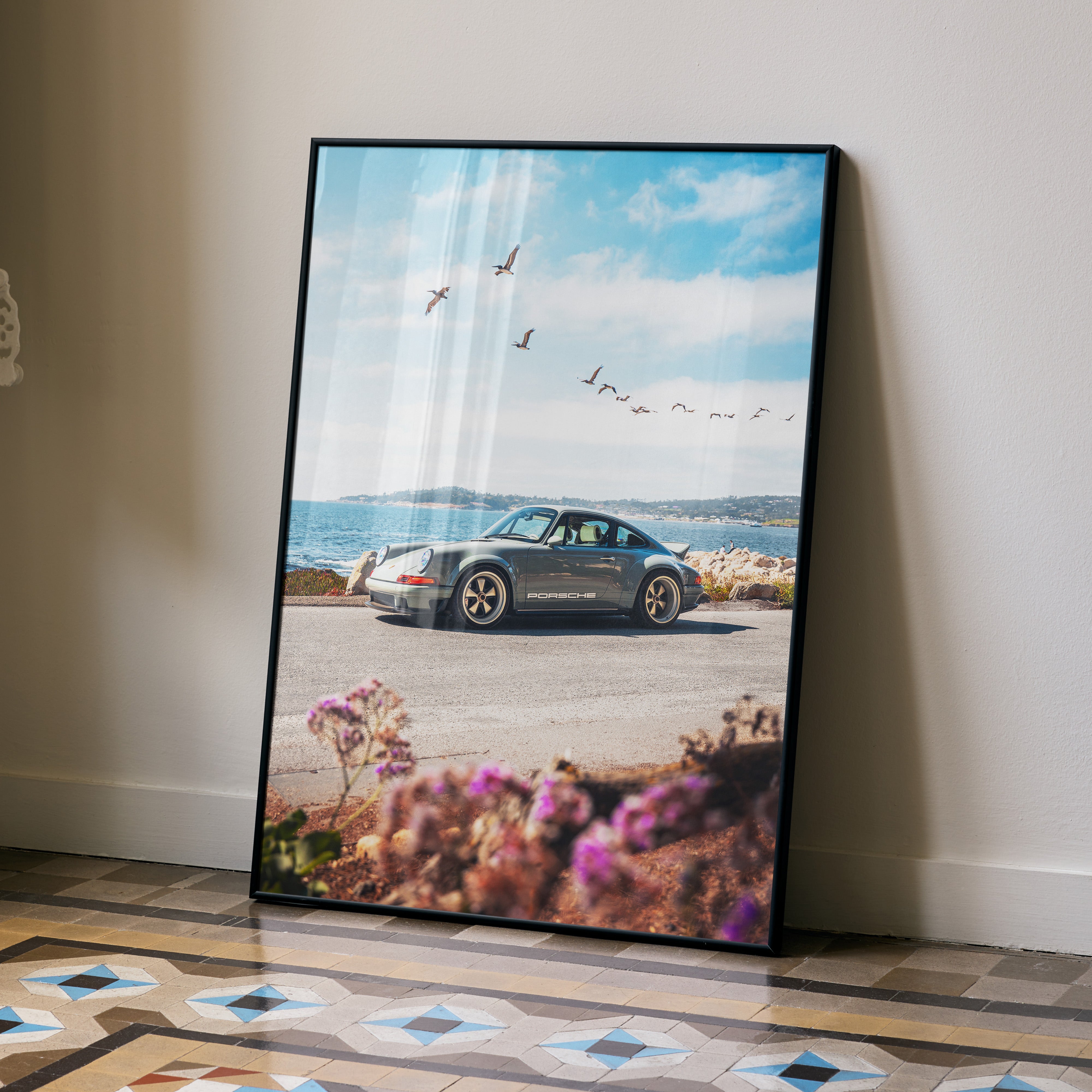 Porsche 911 classic car poster with ocean and sky background wall art in black frame.