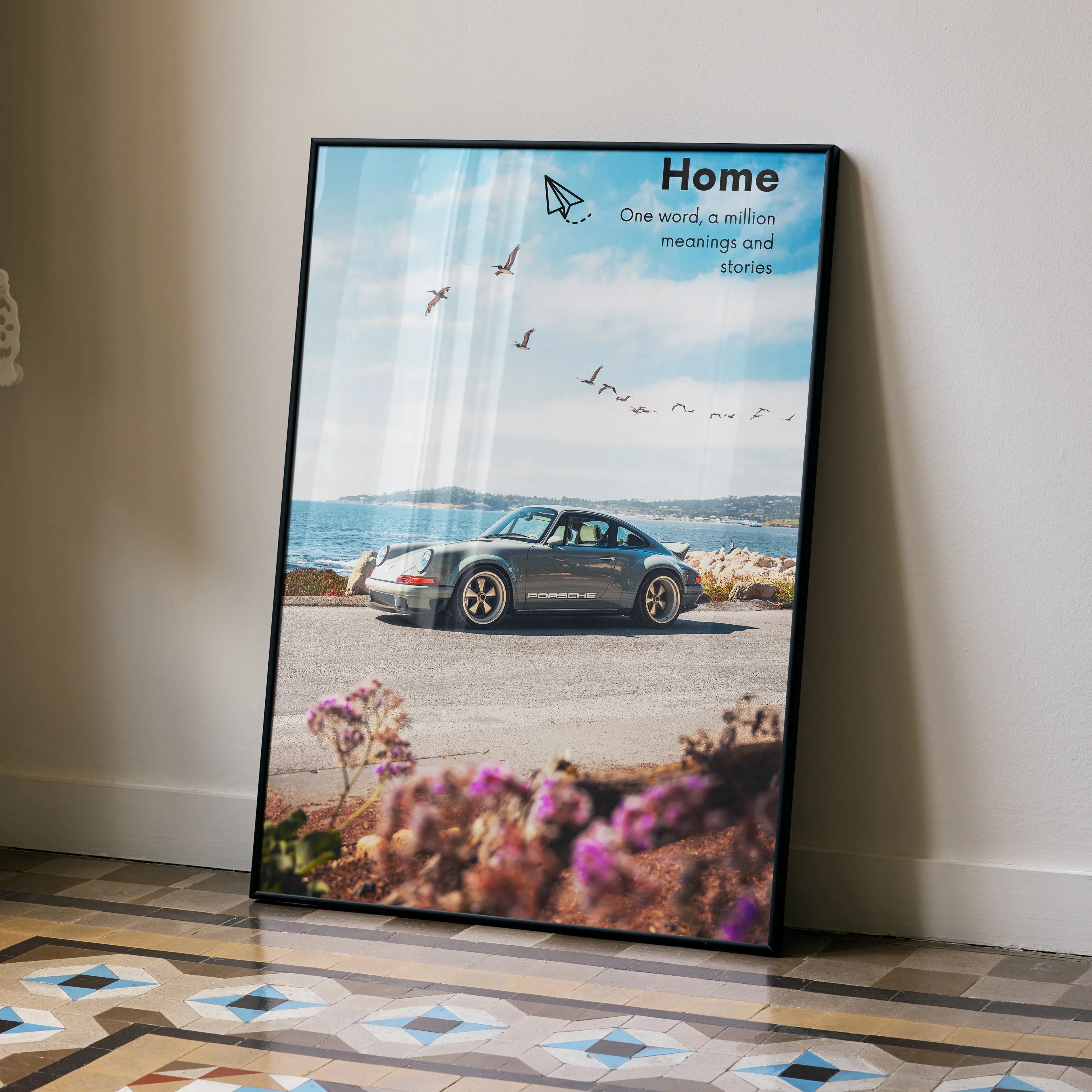 Motivational poster wall art featuring a black Porsche 911 classic car by the coast under a blue sky with inspiring text.