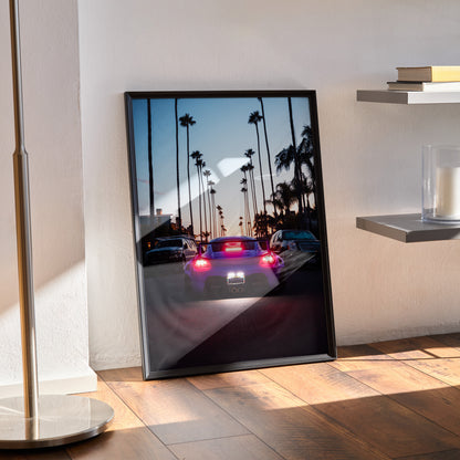 Porsche Cayman car poster with palm trees at sunset, vibrant wall art in black frame.