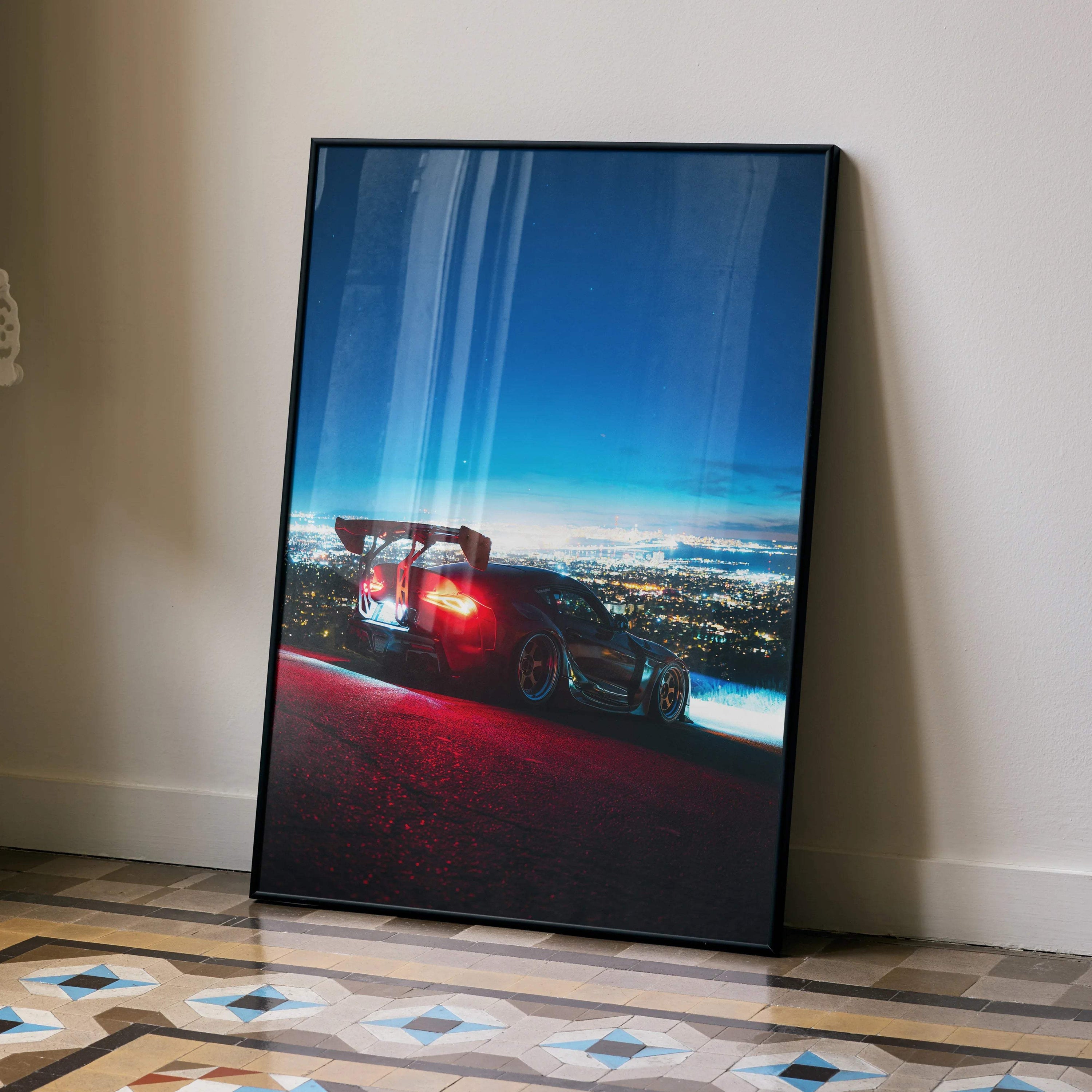 Toyota Supra Mk5 JDM poster wall art featuring a sleek black sports car at night with city lights backdrop.