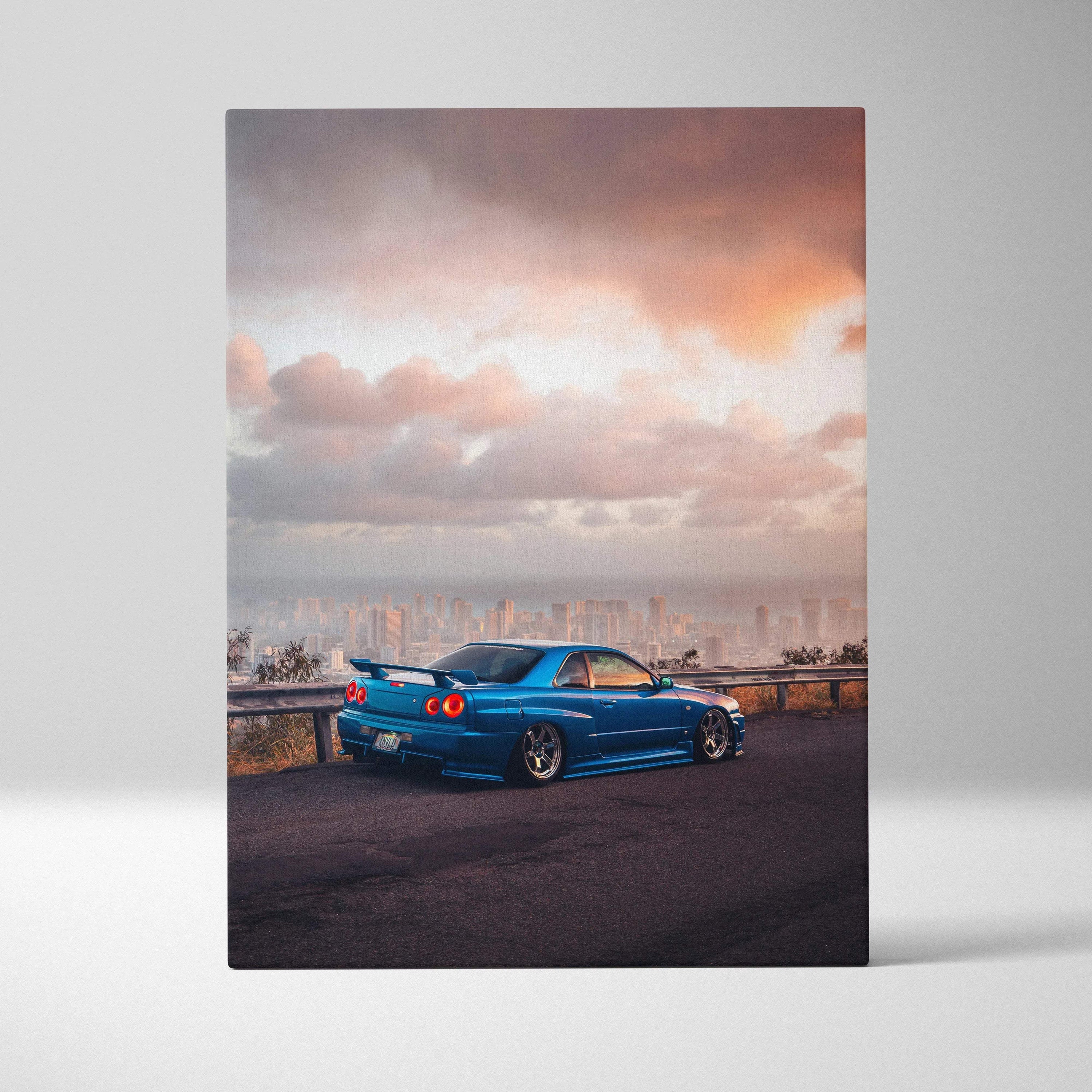 Blue Nissan R34 GTR against sunset sky on canvas wall art vertical car print.