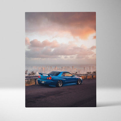 Blue Nissan R34 GTR against sunset sky on canvas wall art vertical car print.