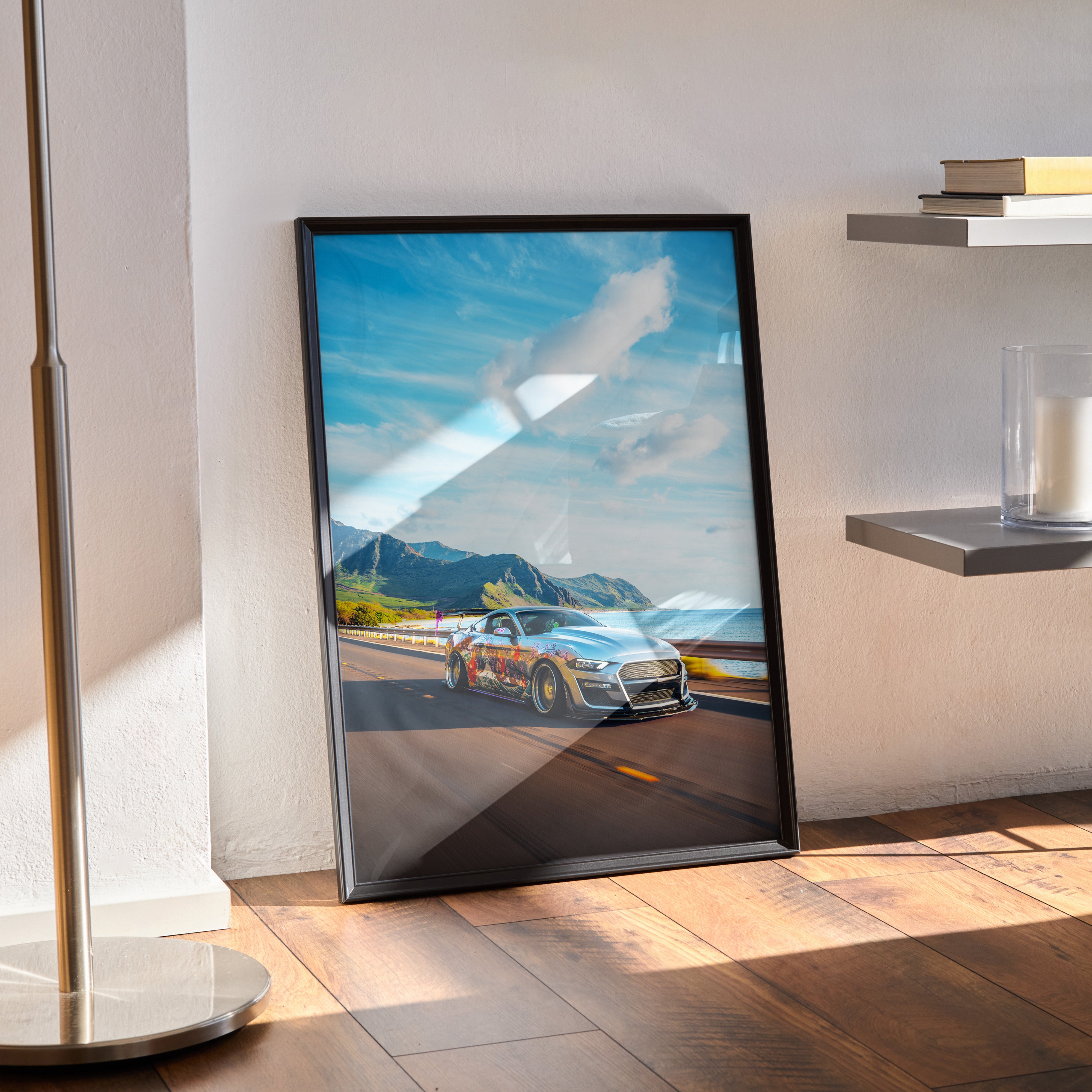 Framed Ford Mustang S550 poster leaning against wall with scenic mountain road background, automotive wall art.