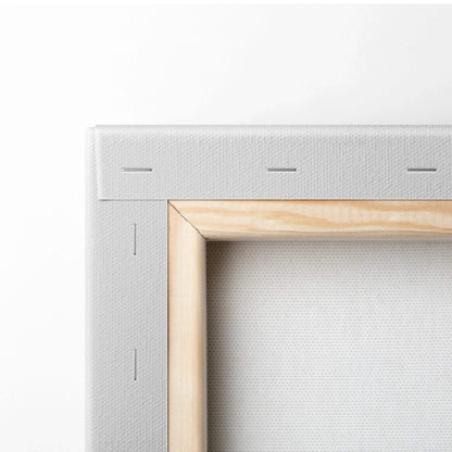 Close-up of stretched white canvas fabric on a wooden frame corner showing staples and texture.