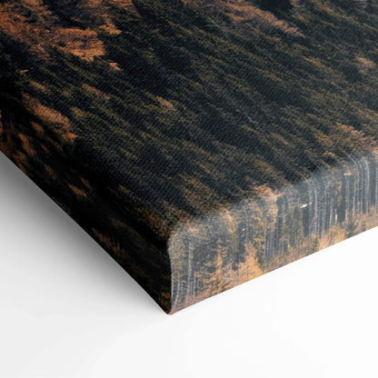 Corner of stretched canvas showing textured black and brown winter mountain landscape art print on wrapped edges.