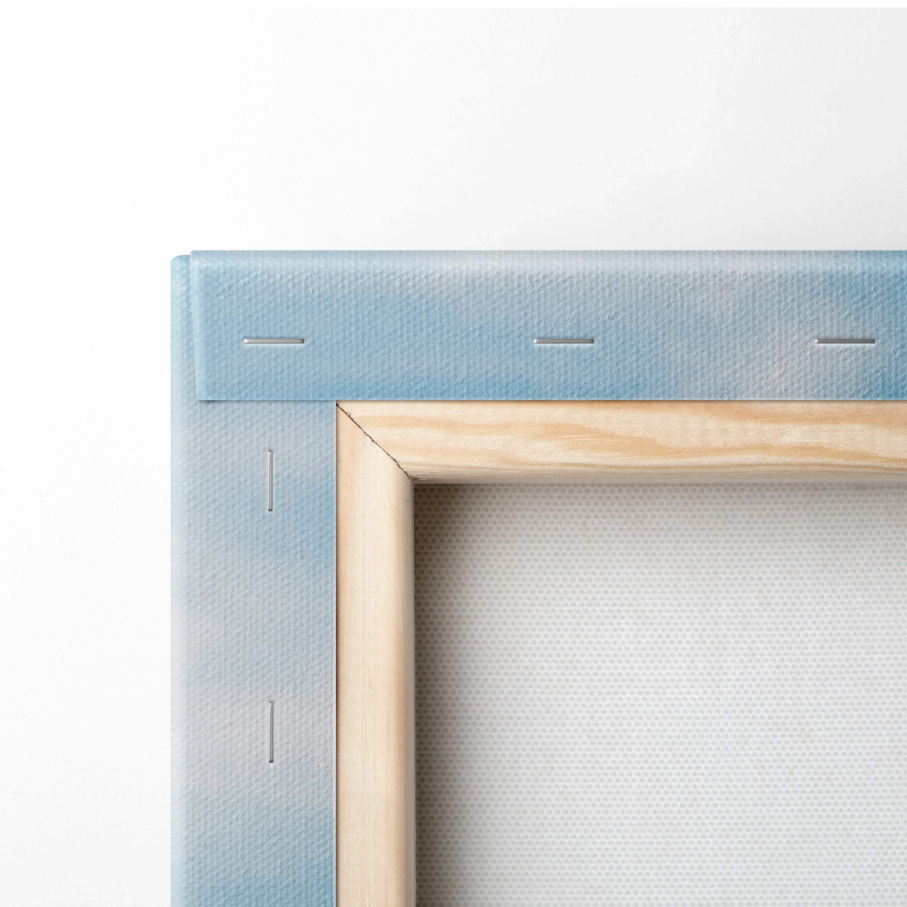 Close-up of stretched canvas corner with light blue painted edges and natural wood frame backing for wall art decor.