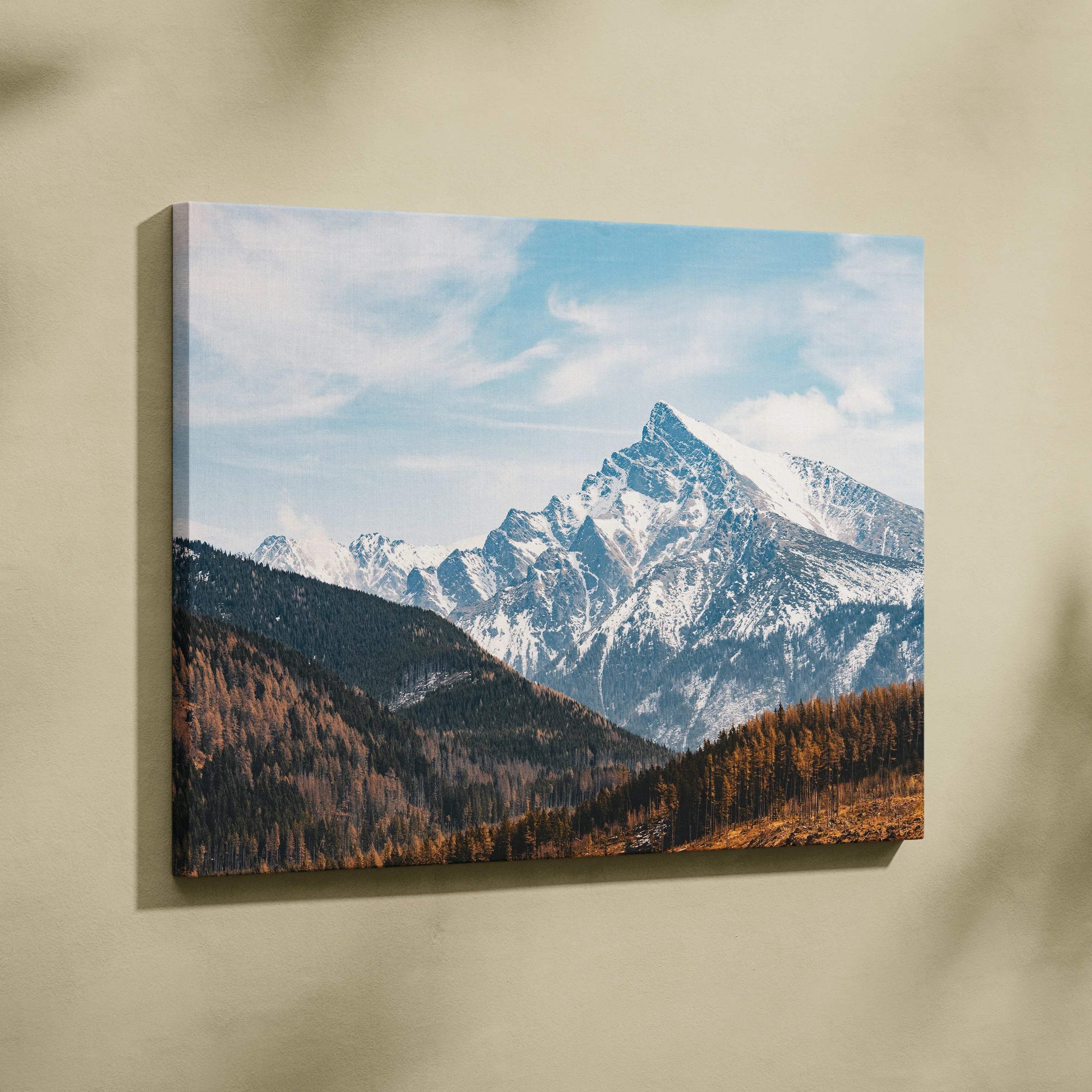 Canvas wall art featuring a snowy mountain peak under a blue sky with scattered clouds.