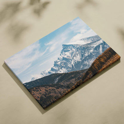 Canvas wall art featuring a snowy mountain landscape under a blue sky with wispy clouds.