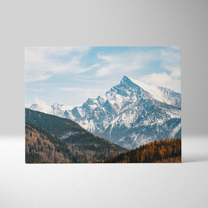 Canvas wall art featuring a digital landscape of snowy mountain peaks under a partly cloudy blue sky.