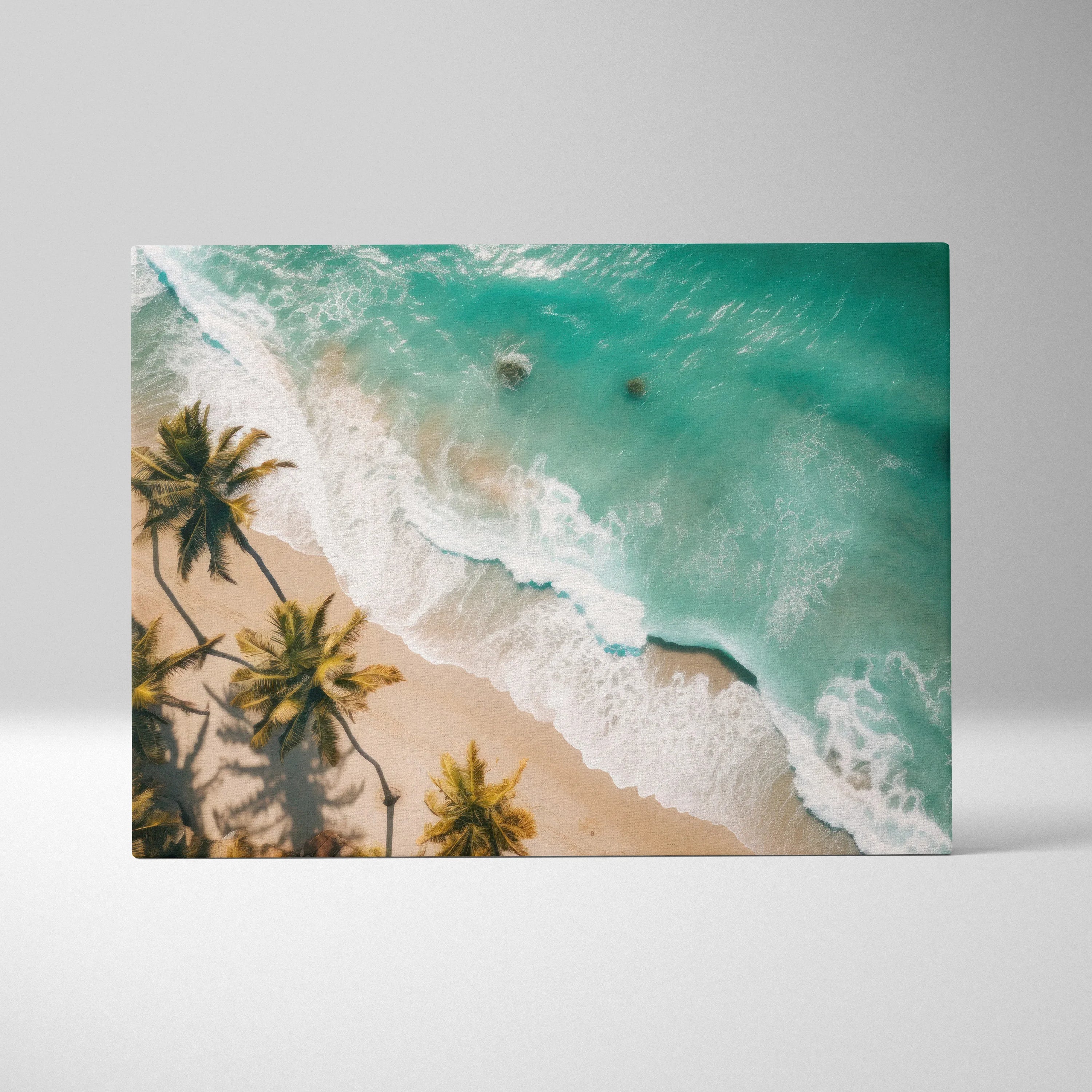 Canvas wall art featuring aerial view of turquoise ocean waves crashing on sandy tropical beach with palm trees.