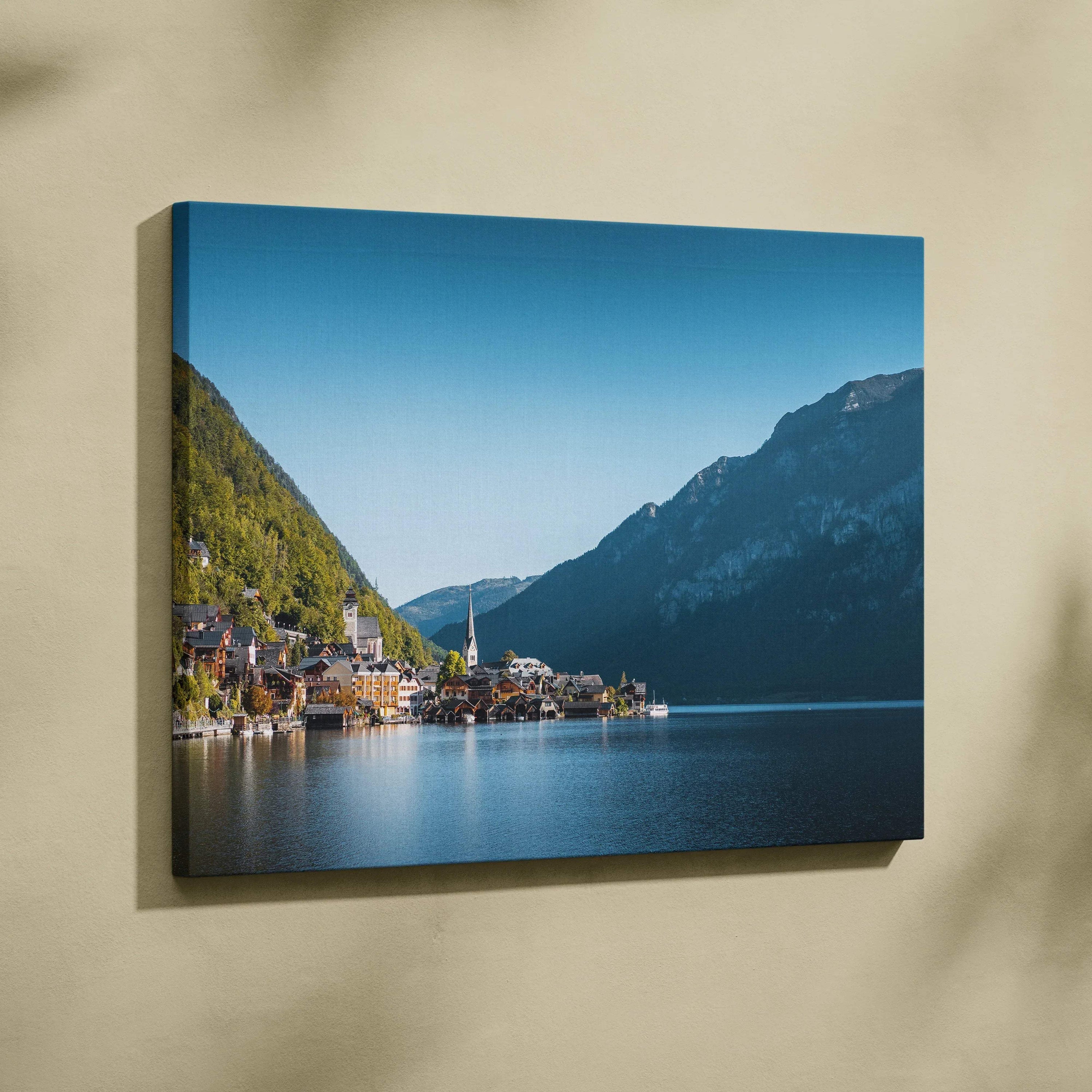Canvas wall art featuring serene lakeside village with mountains under clear blue sky, horizontal orientation.