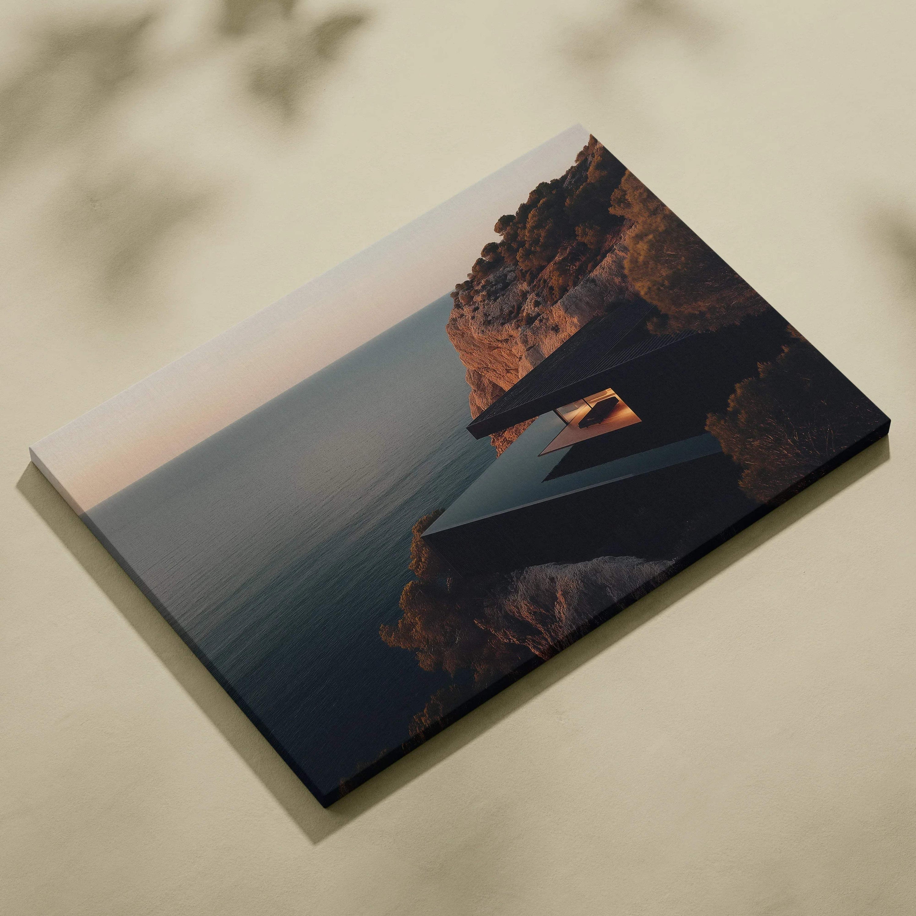 Canvas wall art featuring modern architecture with geometric shapes on a cliff overlooking calm ocean waters at sunset.