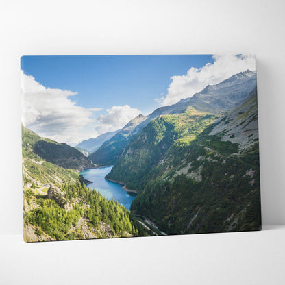 Canvas print of calm lake between mountains, lush valleys, blue sky