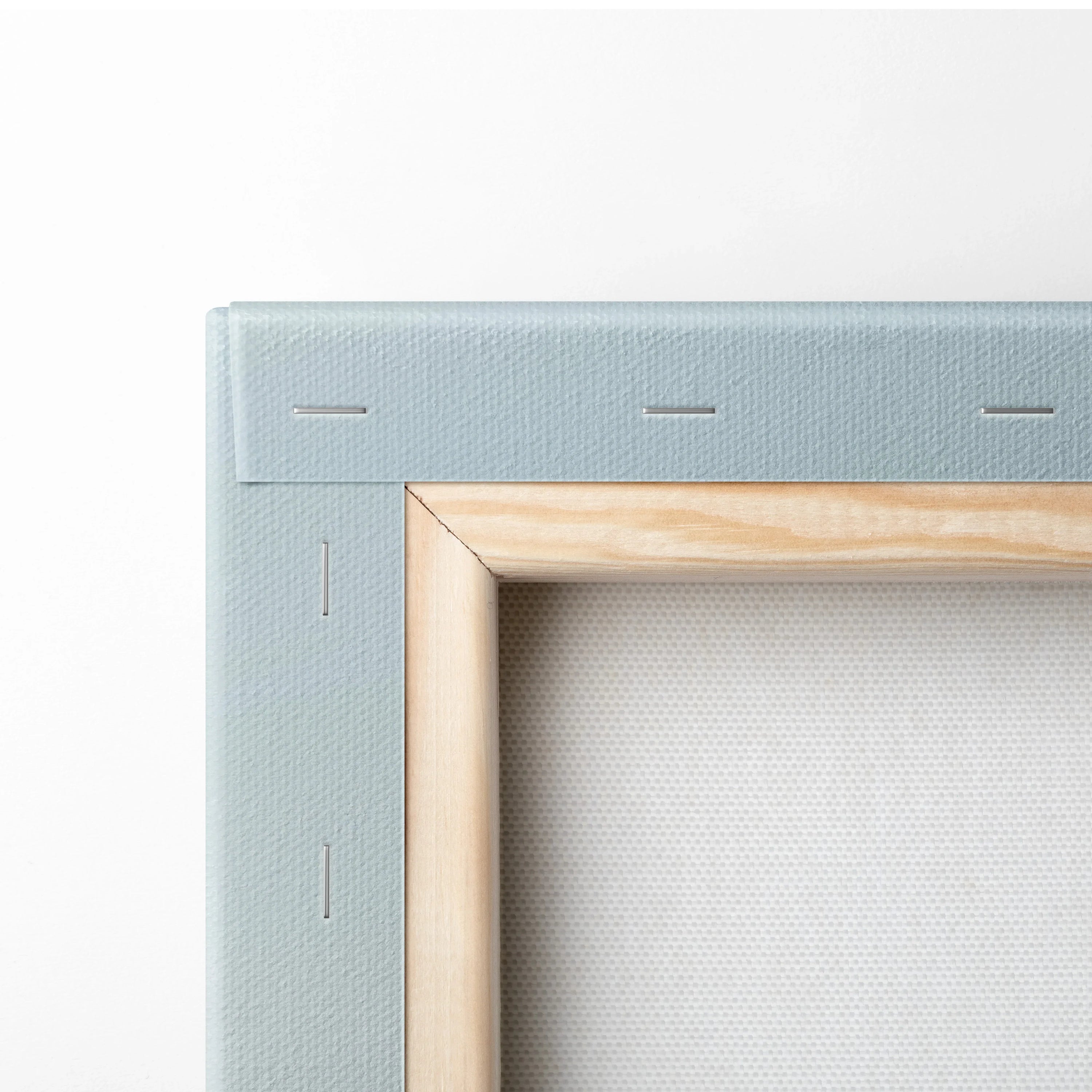 Wooden stretcher frame with white canvas wrapped and stapled for minimalist wall art decor.