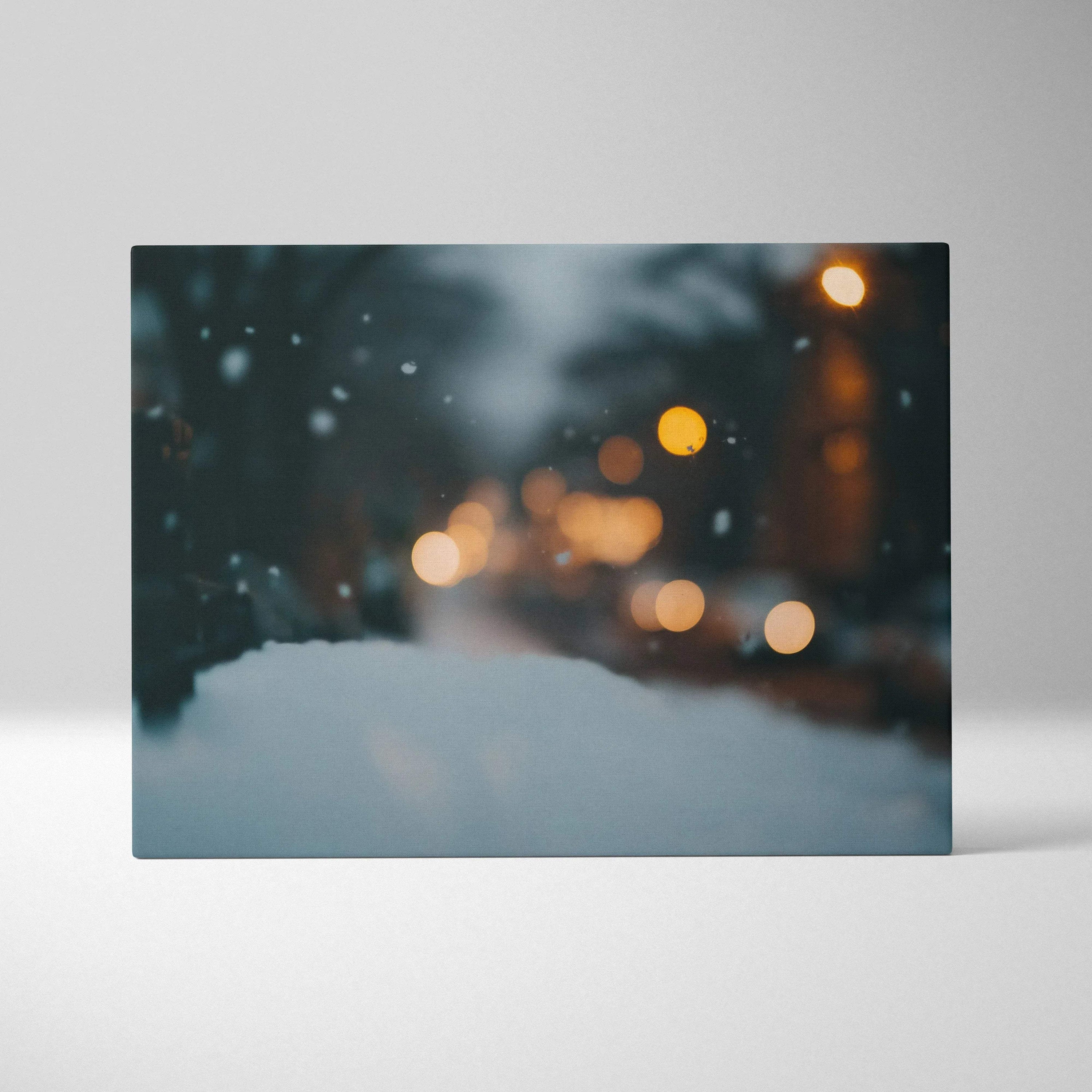 Winter bokeh canvas wall art with blurred snow and warm glowing lights for home decor.