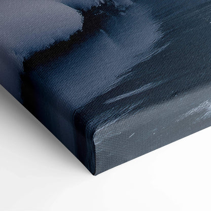 Close-up of canvas wall art showing textured frozen river and snow-covered dark mountain landscape in shades of blue and.