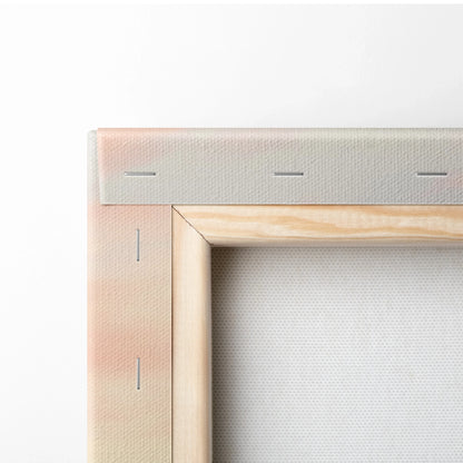 Close-up of white stretched canvas wall art with wooden frame corner and visible staples for decor mounting.