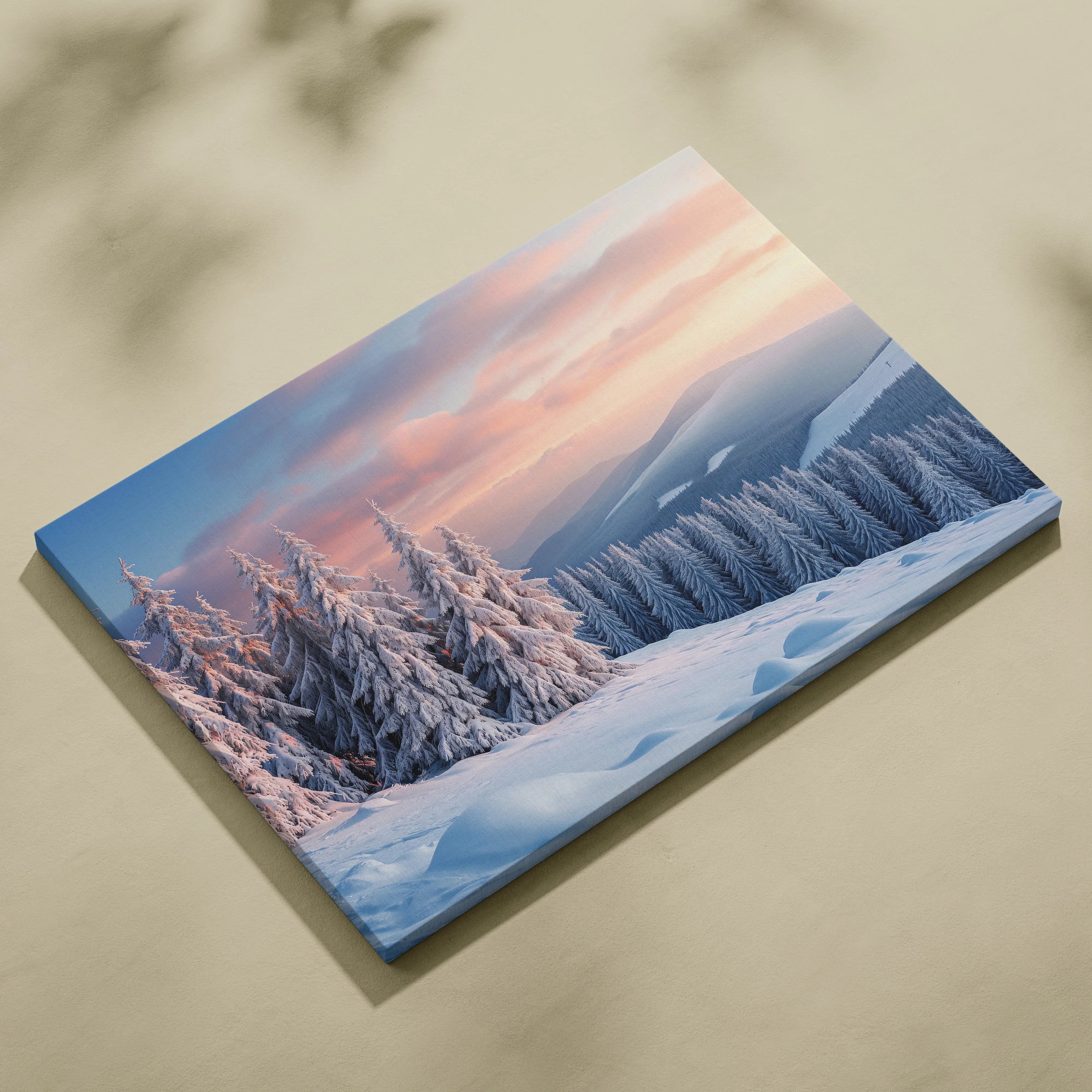Canvas wall art featuring a snowy mountain peak and snow-covered trees at winter sunset with pink and purple sky tones.