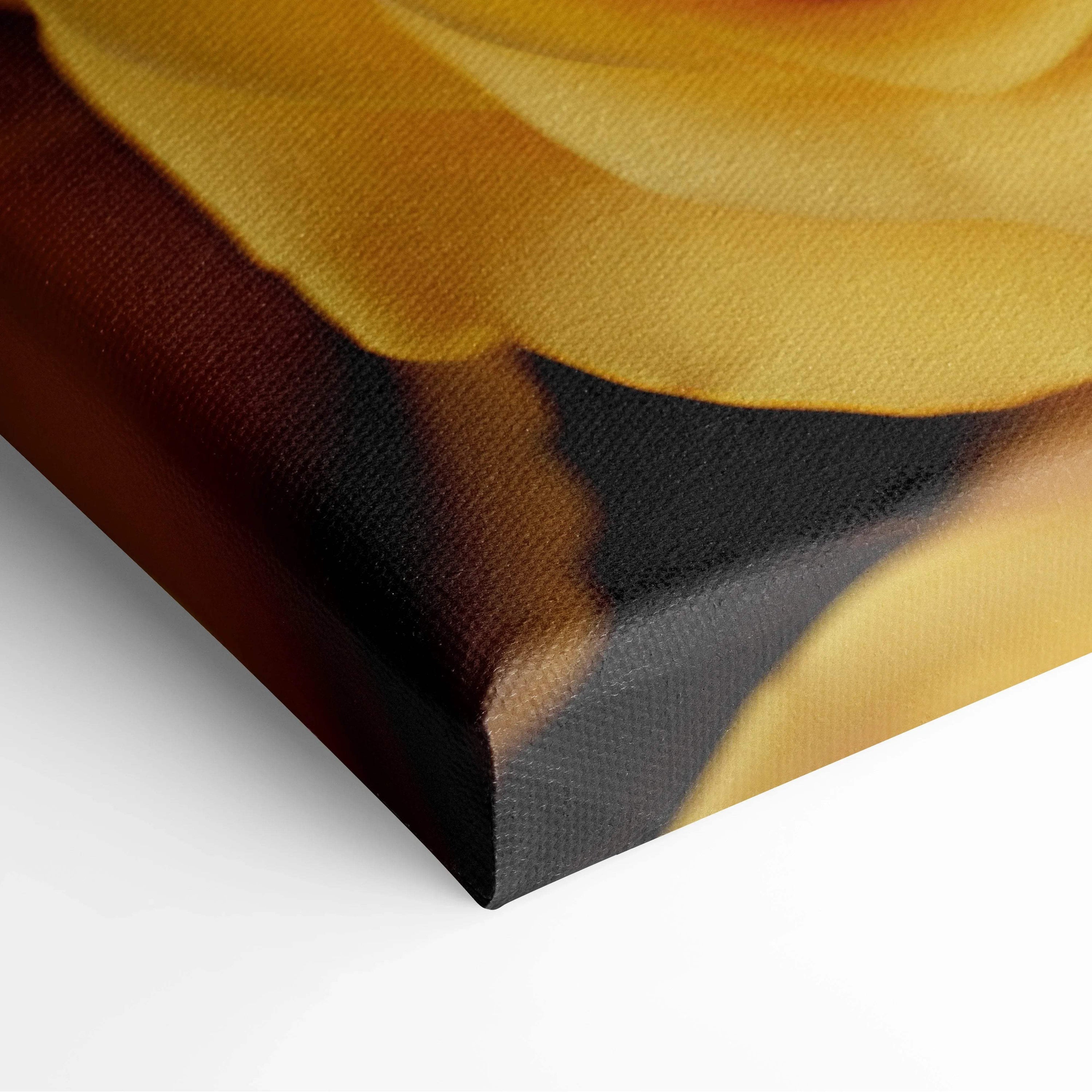 Close-up of canvas wall art featuring vibrant yellow rose petals with rich brown and black shadows for floral decor.
