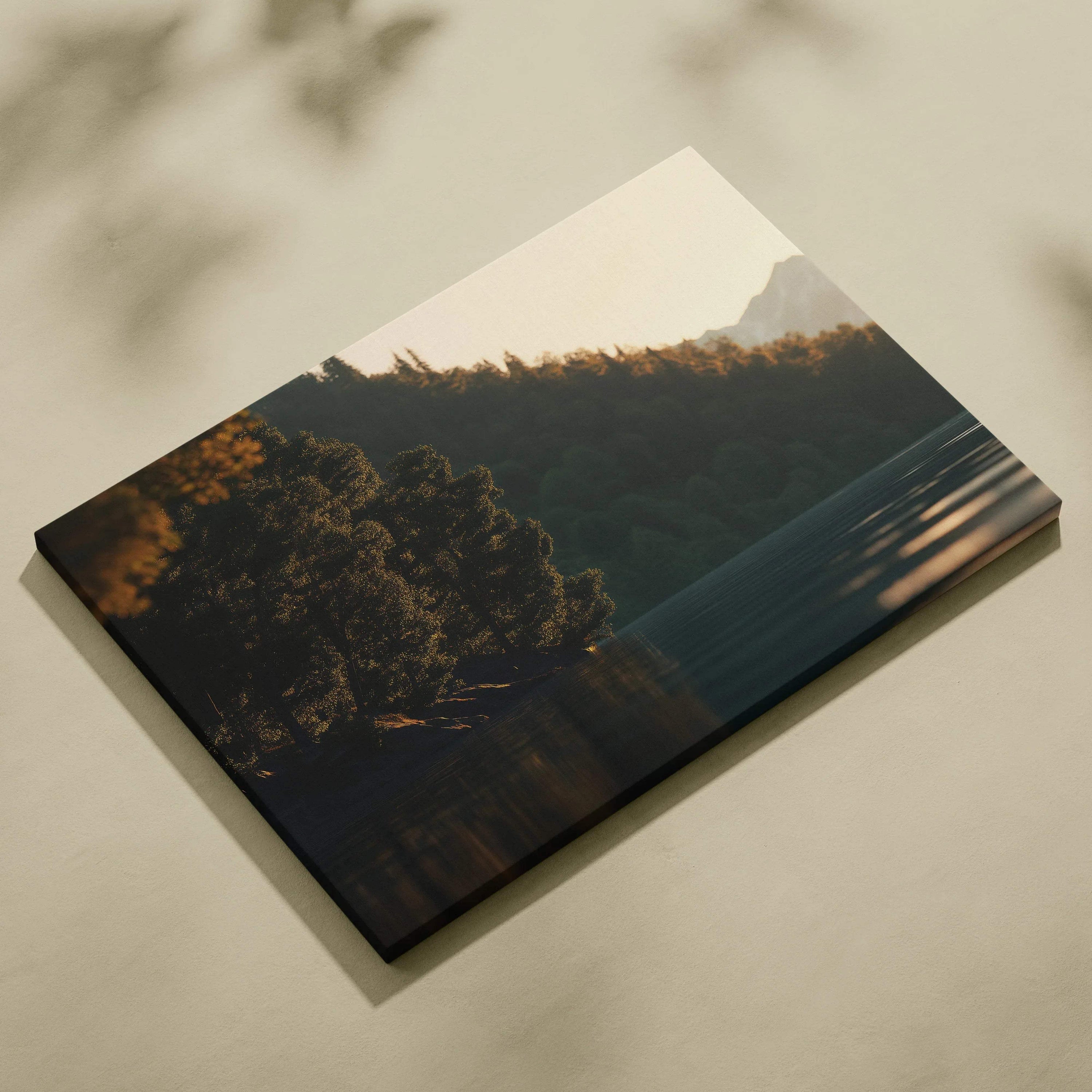 Canvas wall art featuring a serene sunset over forested hills with soft light and shadows.