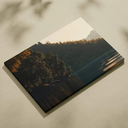 Canvas wall art featuring a serene sunset over forested hills with soft light and shadows.