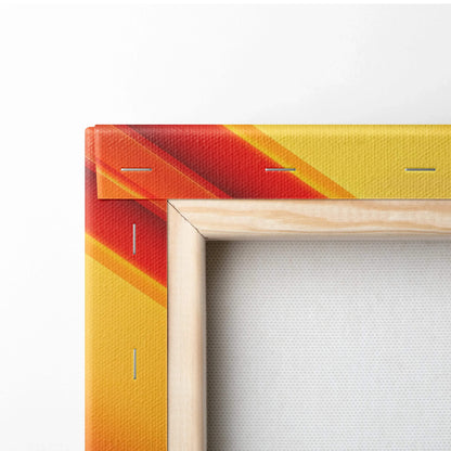 Corner close-up of a yellow and red abstract digital art canvas with wooden frame and visible staples on the edge.