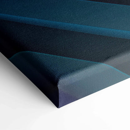 Canvas art with layered abstract shapes in deep blue and teal tones on textured surface.