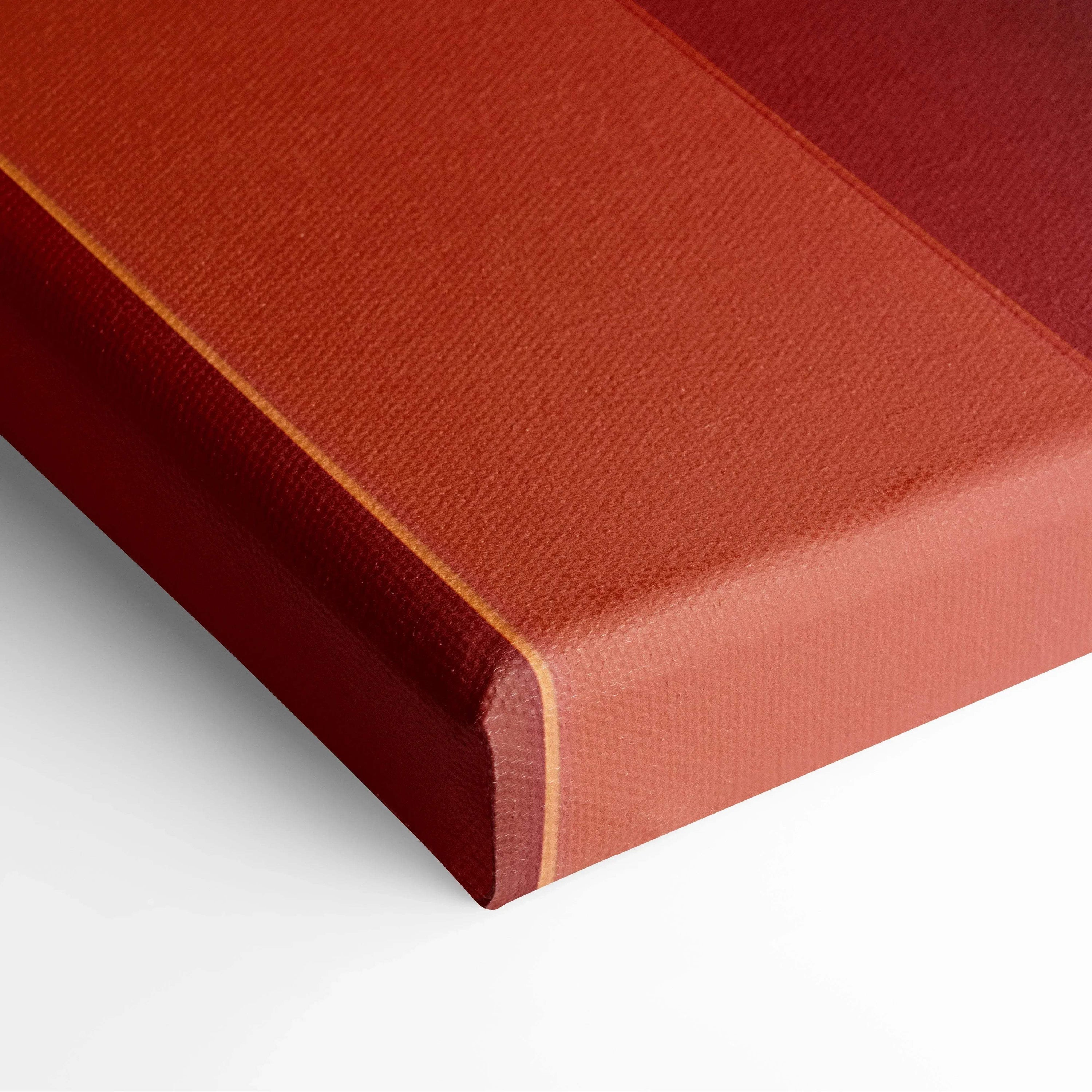 Modern abstract canvas art with rich red and burnt orange tones, textured surface on gallery-wrapped edges.