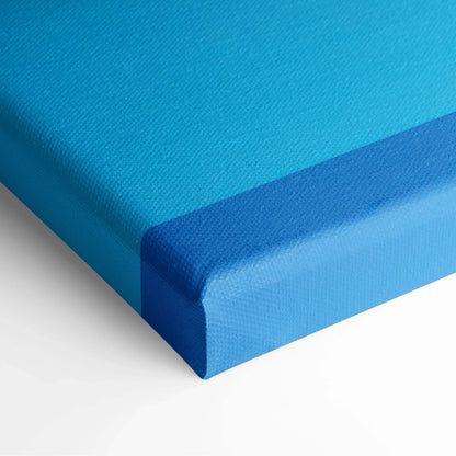 Close-up of abstract digital art canvas print featuring layered blue tones with textured surface and wrapped edges.