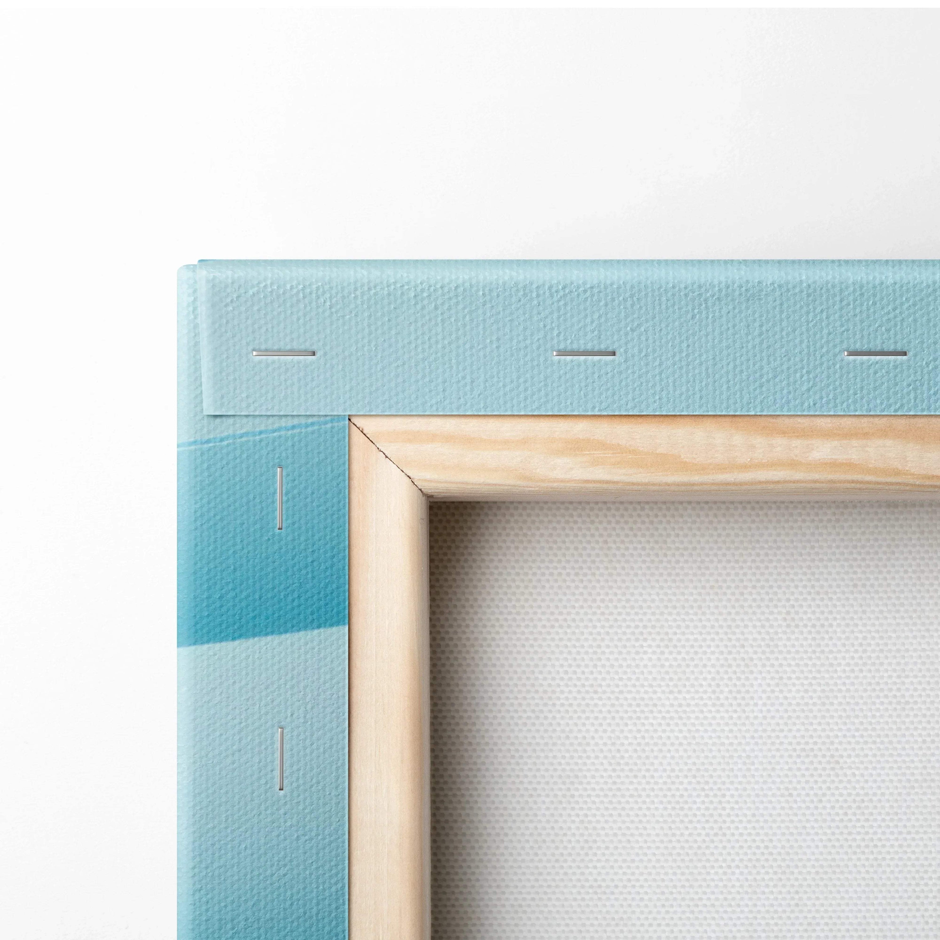 Close-up of stretched canvas with light wooden frame and vibrant blue gradient abstract art wrap around edges.