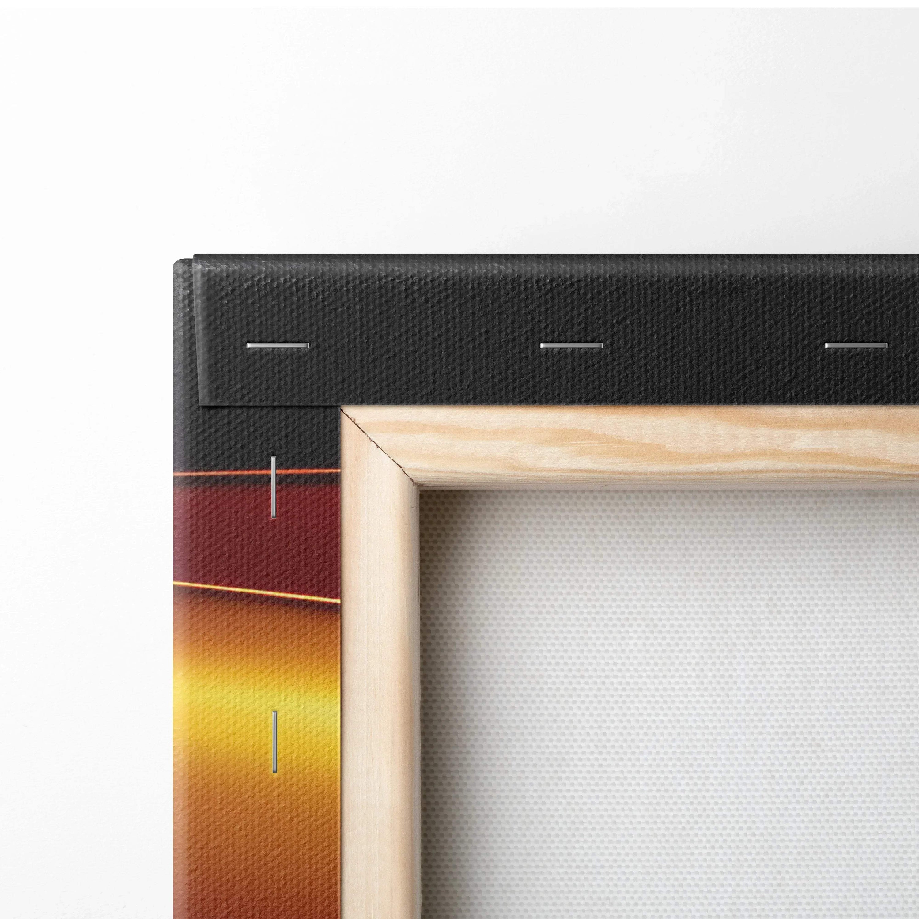 Close-up of wooden frame and black canvas edge with abstract gradient colors in deep red and yellow tones visible on canvas.