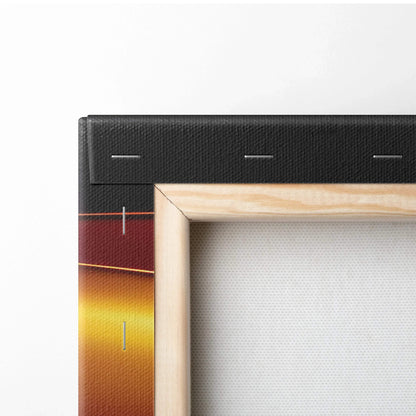 Close-up of wooden frame and black canvas edge with abstract gradient colors in deep red and yellow tones visible on canvas.