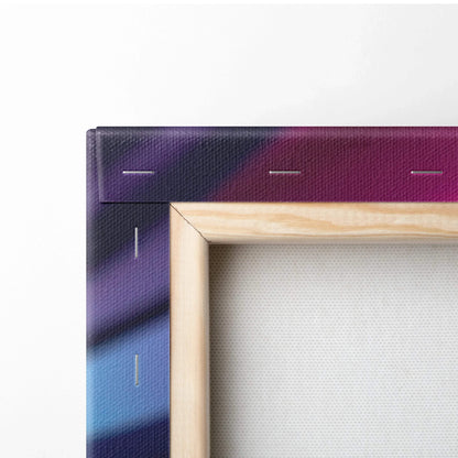 Close-up of wooden frame and stapled edge on abstract purple and blue canvas wall art.