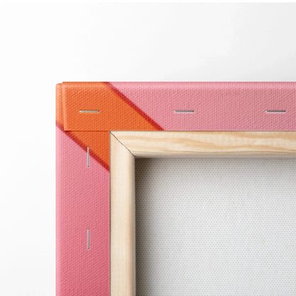 Corner detail of wooden-framed canvas with pink and orange abstract digital print.