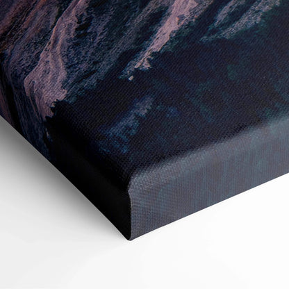 Close-up of canvas wall art showing textured print of dark blue and purple mountain sunset scene.