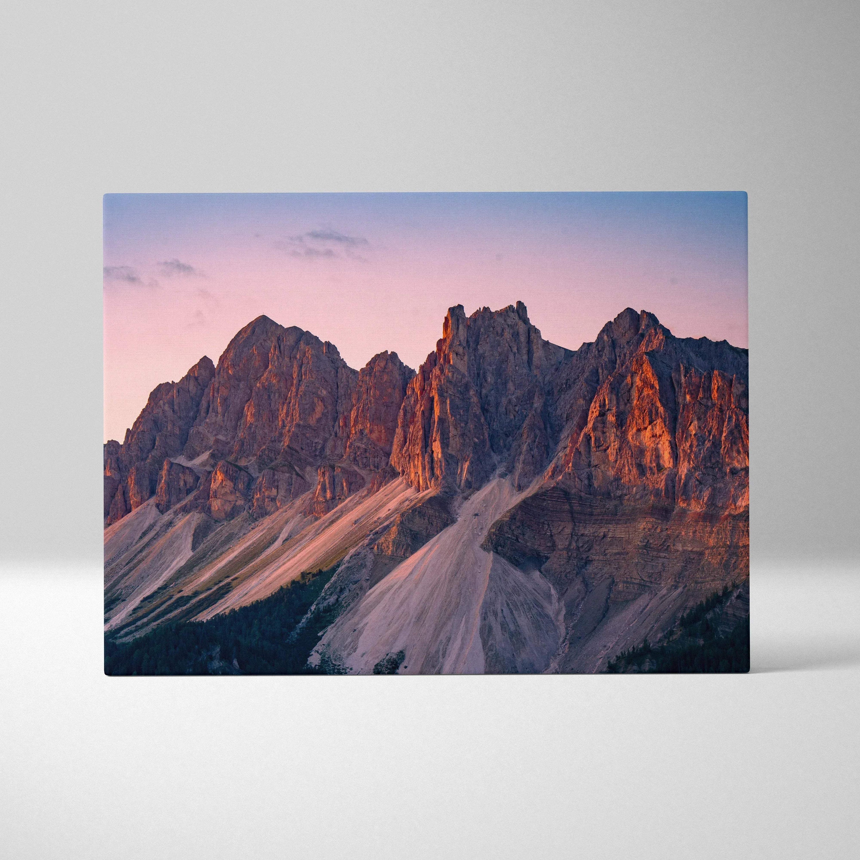 Canvas wall art featuring rugged mountain peaks bathed in warm sunset light.