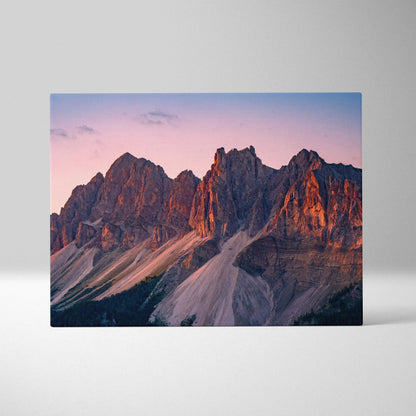 Canvas wall art featuring rugged mountain peaks bathed in warm sunset light.