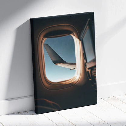 Canvas wall art featuring an airplane wing viewed through a window with soft natural light shadows.