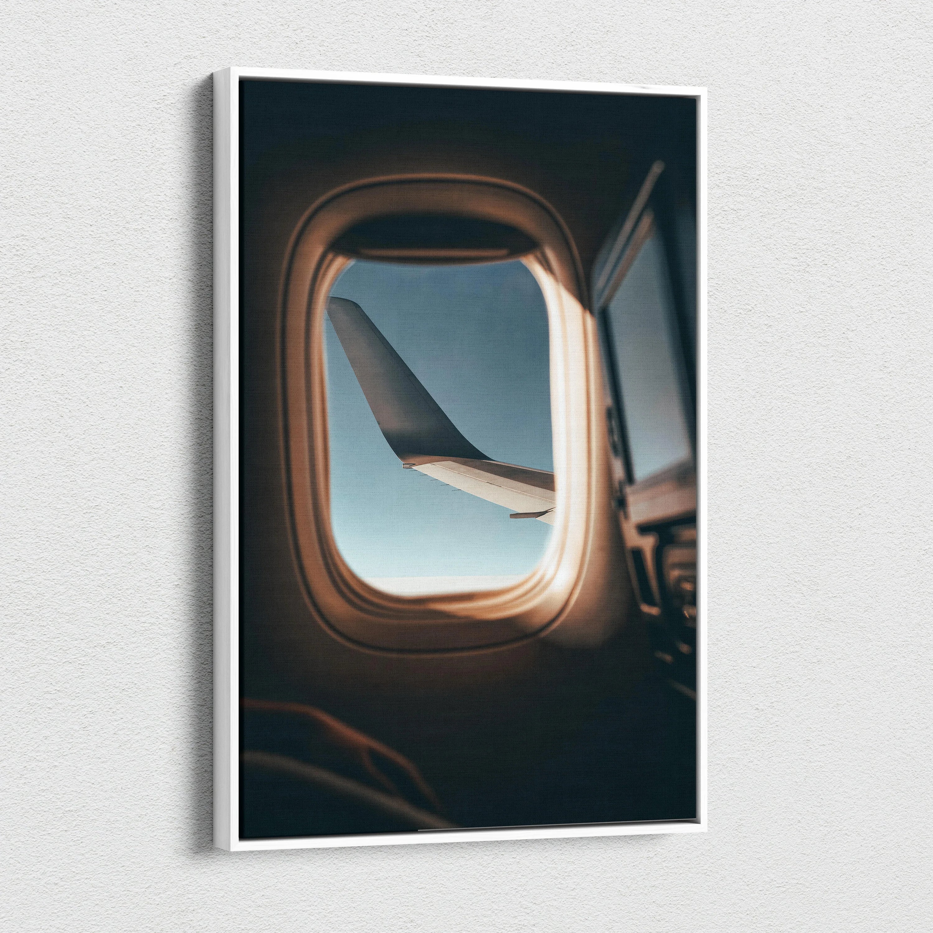 Vertical canvas wall art showing airplane wing through window with soft natural light.