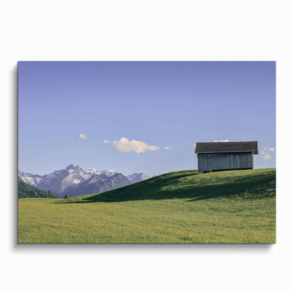 Majestic mountain landscape with green hill and wooden barn poster wall art.