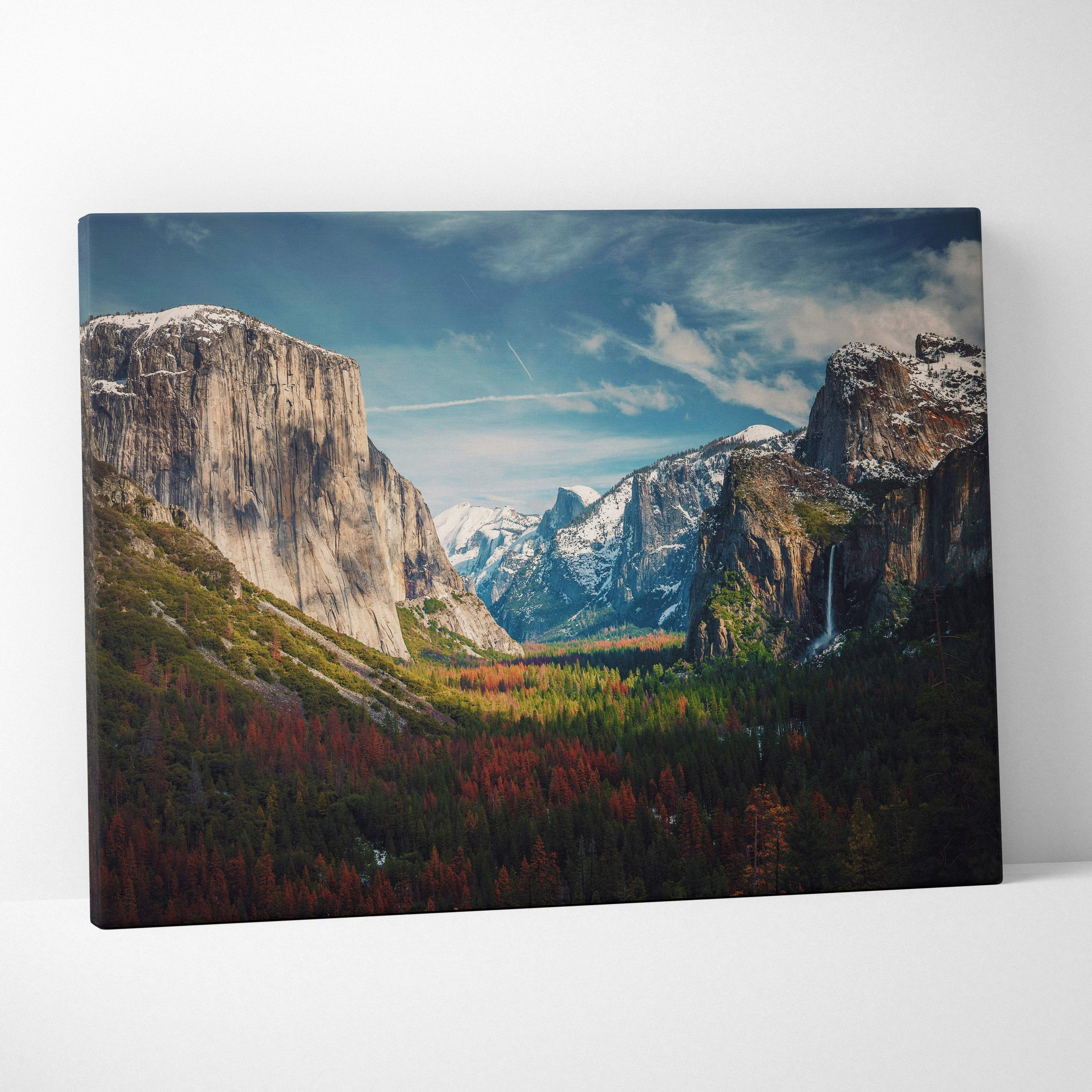 A framed canvas print of yosemite valley mountain landscape with autumn forests and waterfall for rustic cabin decor