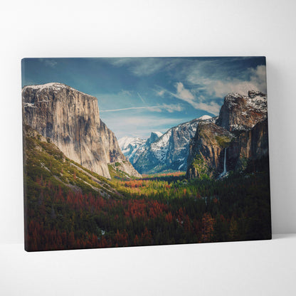 A framed canvas print of yosemite valley mountain landscape with autumn forests and waterfall for rustic cabin decor