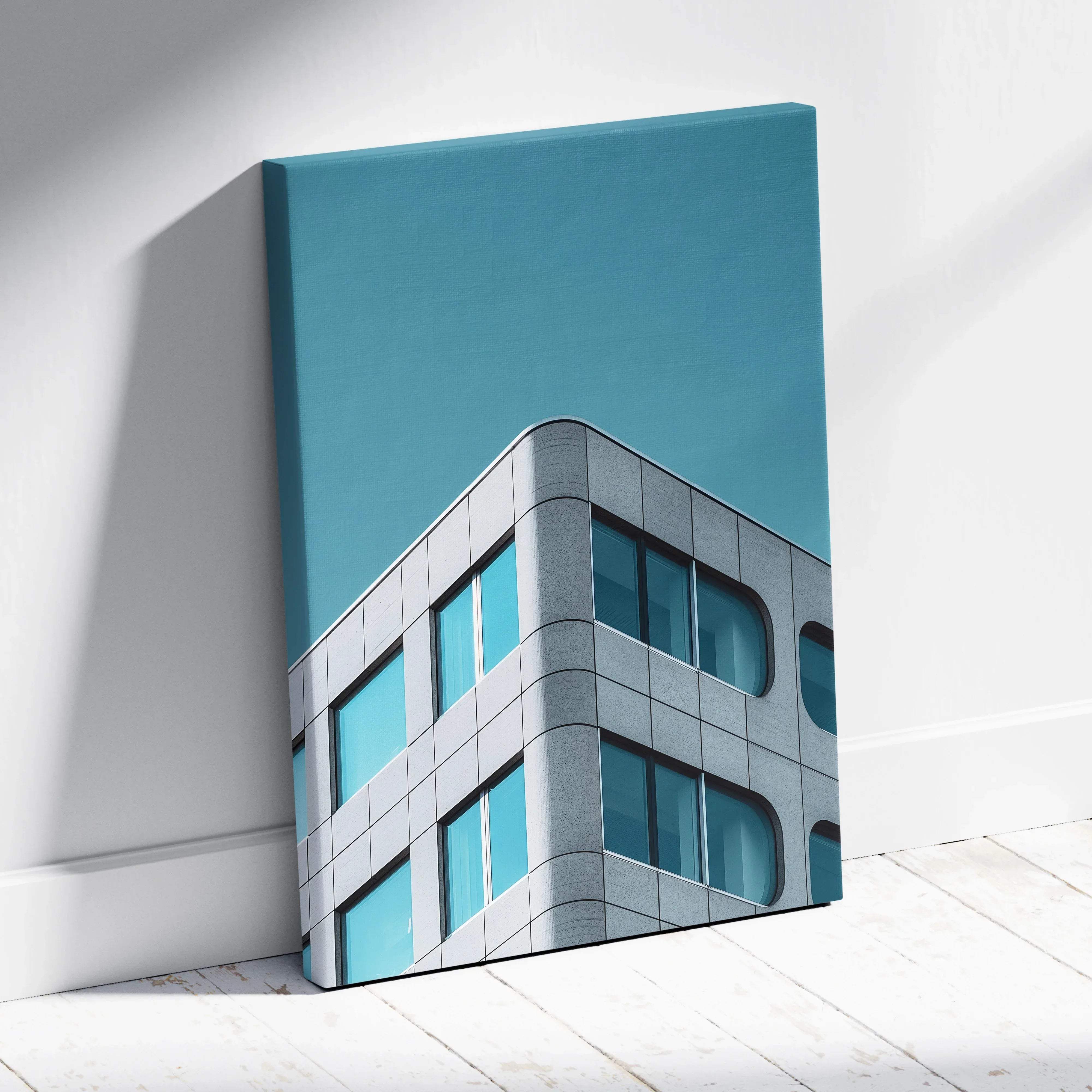 Modern architecture canvas wall art featuring a sleek gray building with teal windows against a calm blue sky background